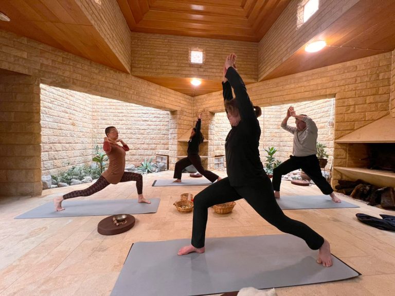 Group doing yoga indoors at Ariadnes Garden